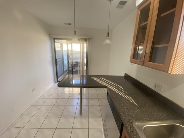 kitchen featuring glass insert cabinets, hanging light fixtures, light tile patterned floors, dishwasher, and visible vents