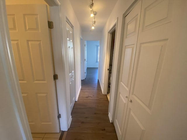 hall with dark wood finished floors and baseboards
