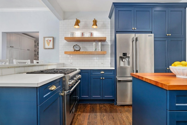 kitchen with high end appliances, decorative backsplash, and blue cabinetry
