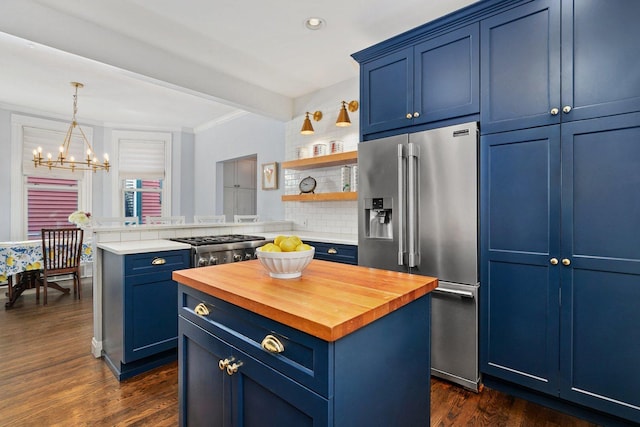 kitchen with wood counters, a chandelier, high quality fridge, and blue cabinets