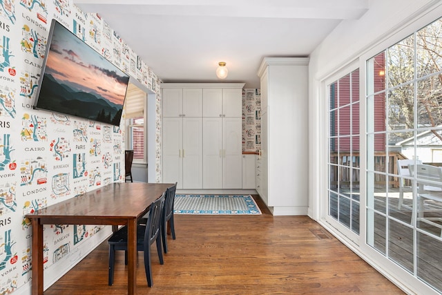 dining area with visible vents, baseboards, and wood finished floors