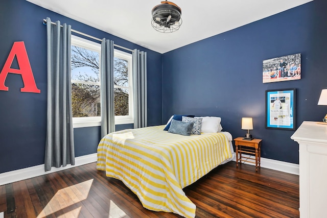 bedroom with baseboards and hardwood / wood-style flooring