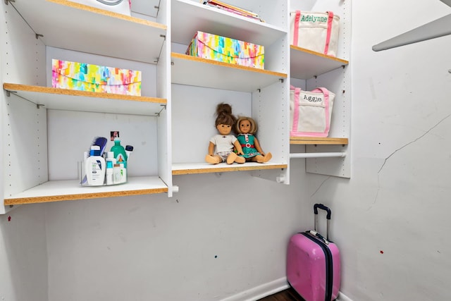 clothes washing area with baseboards
