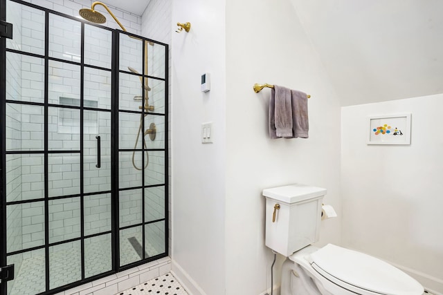 bathroom featuring baseboards, a shower stall, toilet, and lofted ceiling