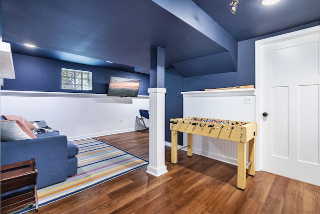 rec room featuring a wainscoted wall, ornate columns, and wood finished floors