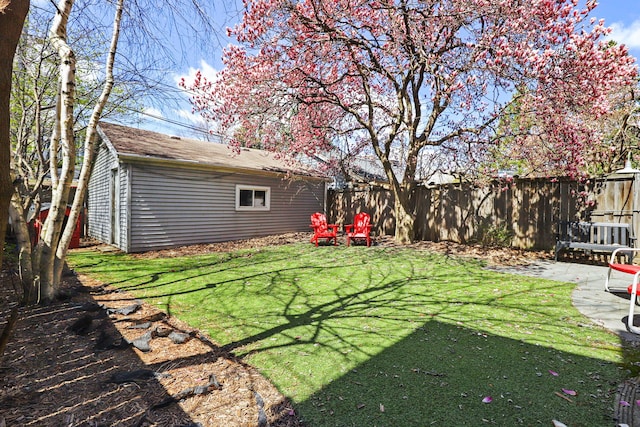 view of yard featuring fence and an outbuilding