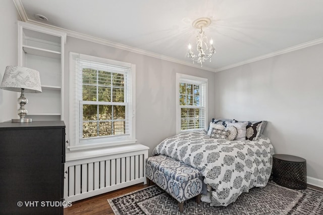 bedroom with radiator, a chandelier, ornamental molding, wood finished floors, and multiple windows