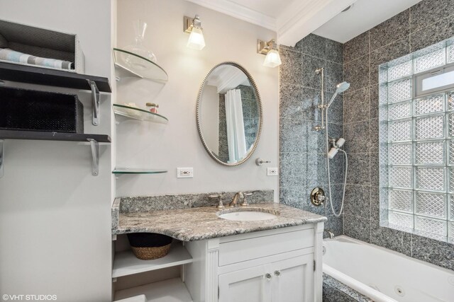 full bath featuring tiled shower / bath combo, vanity, and crown molding
