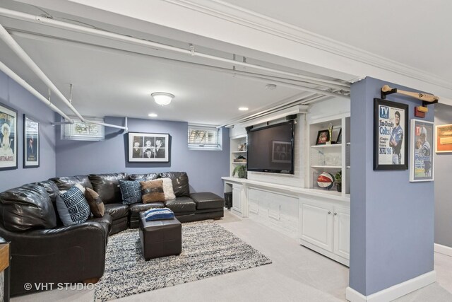living room featuring light carpet, built in shelves, and recessed lighting