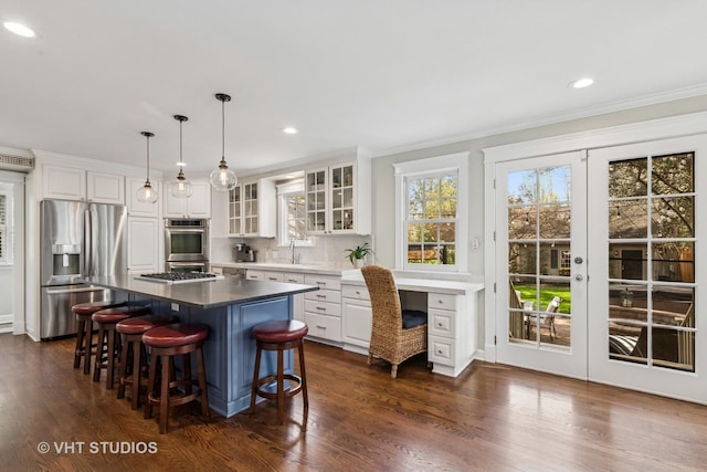 kitchen featuring stainless steel fridge, a sink, crown molding, french doors, and white cabinets