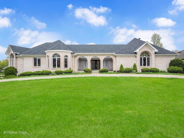 view of front of property with brick siding and a front lawn