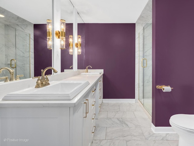 bathroom with baseboards, a sink, marble finish floor, and a stall shower