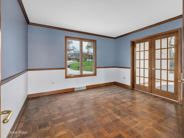 unfurnished room featuring visible vents, baseboards, crown molding, and french doors