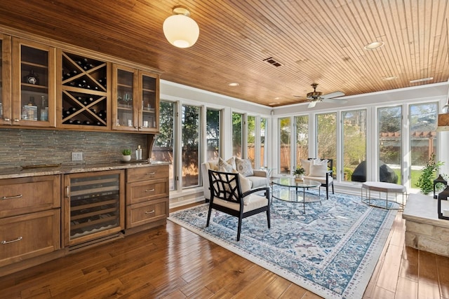 sunroom with wood ceiling, plenty of natural light, bar area, and beverage cooler