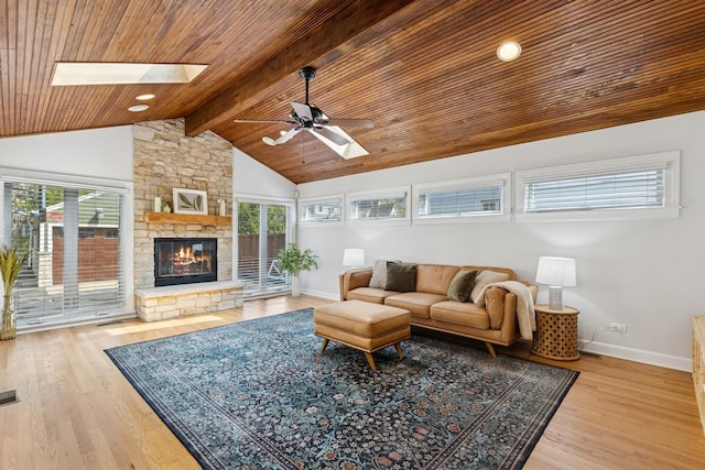 living area featuring a skylight, ceiling fan, and a wealth of natural light