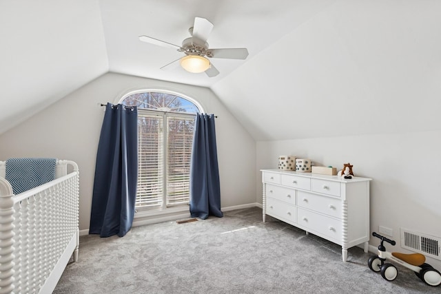 carpeted bedroom with baseboards, a ceiling fan, vaulted ceiling, and visible vents