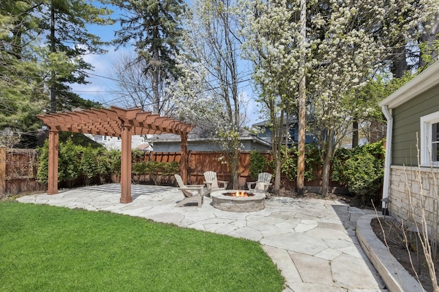 view of yard featuring a patio, an outdoor fire pit, fence, and a pergola