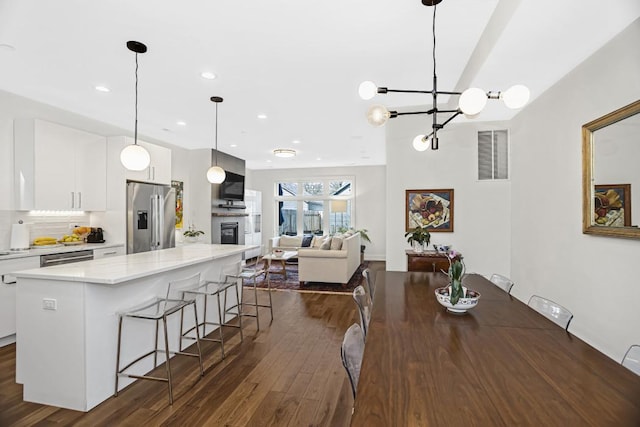 1122 Pitner Ave, Evanston, IL 60202 - dining room featuring dark wood-type flooring, a chandelier, and recessed lighting