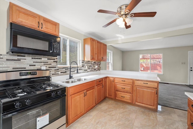 15 N Hillcrest Ave, Fox Lake, IL 60020 - kitchen with stainless steel gas stove, black microwave, ceiling fan, a sink, and backsplash