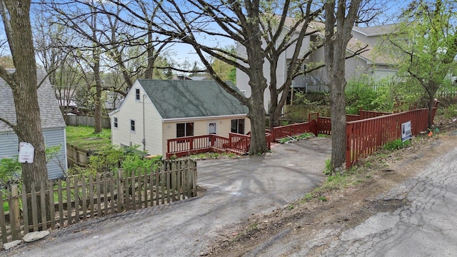 15 N Hillcrest Ave, Fox Lake, IL 60020 - view of front of house featuring fence, a shingled roof, and a deck