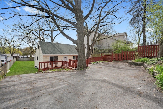 15 N Hillcrest Ave, Fox Lake, IL 60020 - exterior space with a front lawn, a wooden deck, and fence