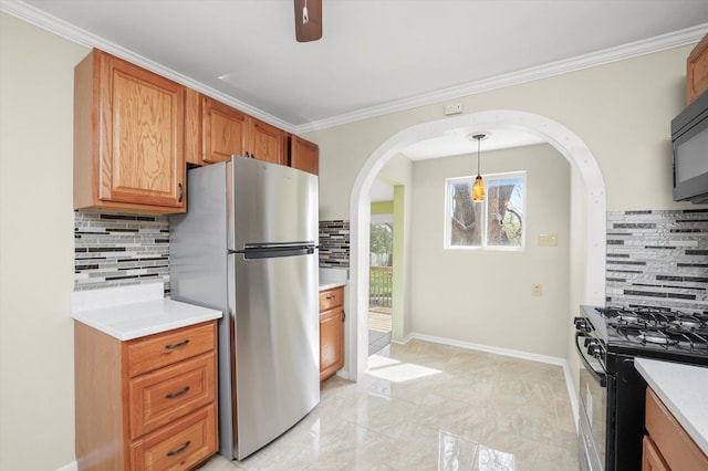 15 N Hillcrest Ave, Fox Lake, IL 60020 - kitchen featuring arched walkways, freestanding refrigerator, backsplash, and gas range oven