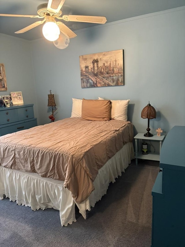 bedroom featuring dark colored carpet and a ceiling fan