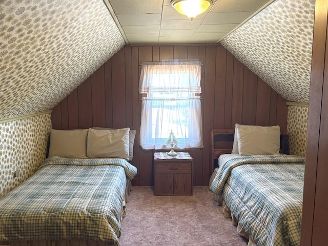bedroom featuring carpet floors, vaulted ceiling, and wood walls