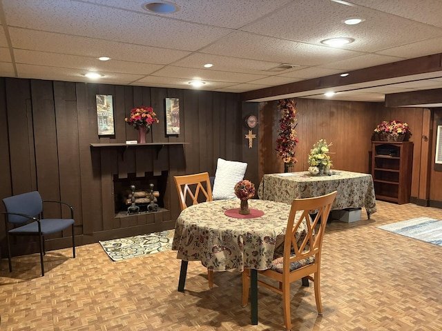 dining room with parquet flooring and wood walls