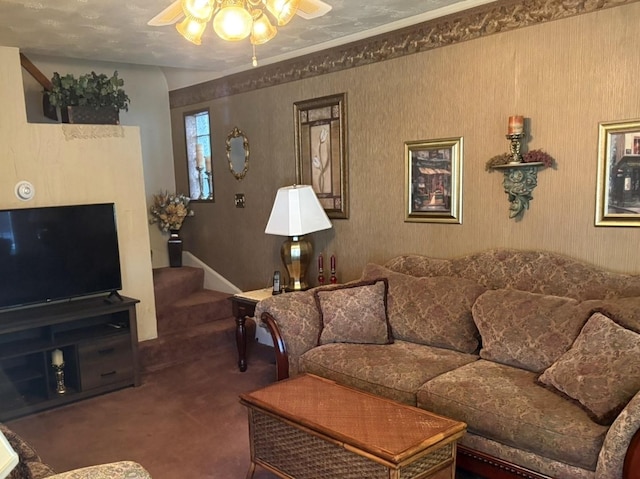 living room featuring carpet floors, ceiling fan, and stairway