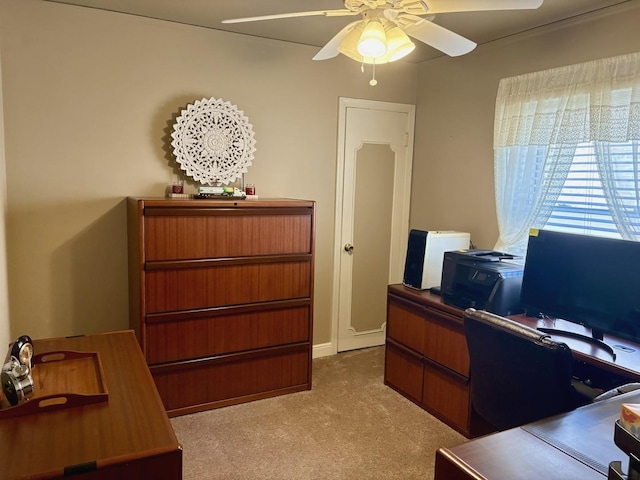 carpeted office space with ceiling fan