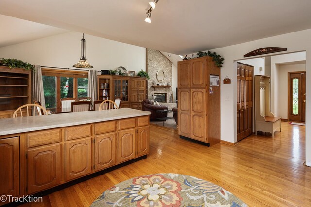 2803 Monterra Dr, Spring Grove, IL 60081 - kitchen with light wood-style floors, light countertops, a fireplace, and vaulted ceiling