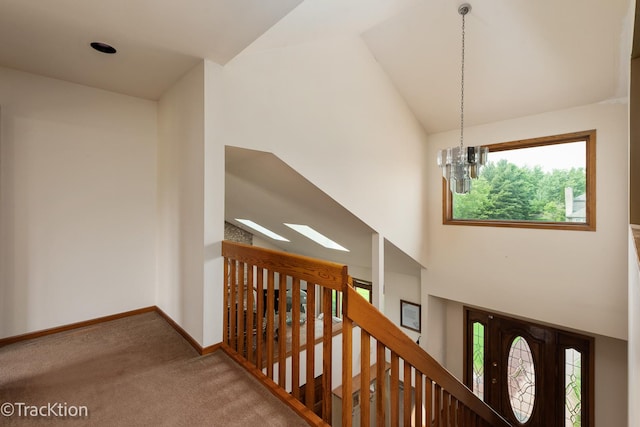 2803 Monterra Dr, Spring Grove, IL 60081 - hall featuring carpet floors, plenty of natural light, a chandelier, an upstairs landing, and high vaulted ceiling