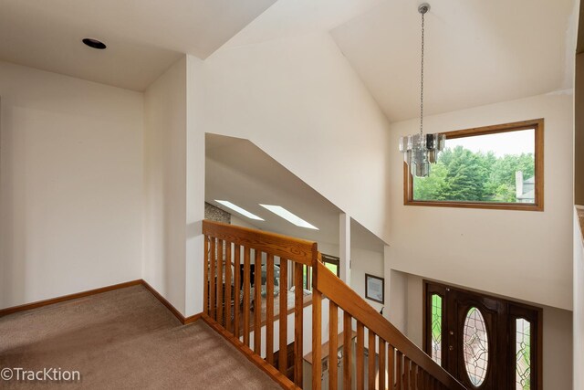 2803 Monterra Dr, Spring Grove, IL 60081 - hall featuring carpet floors, plenty of natural light, a chandelier, an upstairs landing, and high vaulted ceiling
