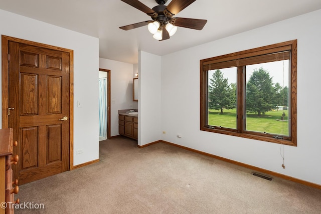 2803 Monterra Dr, Spring Grove, IL 60081 - unfurnished bedroom featuring light colored carpet, baseboards, ensuite bathroom, a sink, and ceiling fan