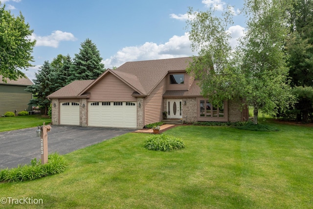 2803 Monterra Dr, Spring Grove, IL 60081 - view of front of house featuring driveway, an attached garage, brick siding, and a front yard