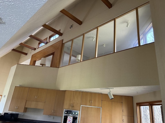 room details with a textured ceiling and oven