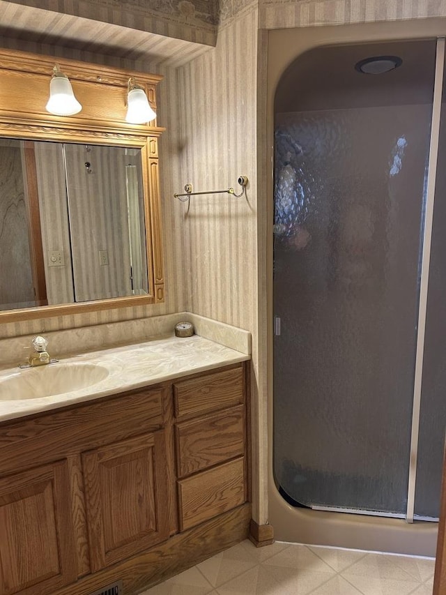 bathroom featuring a stall shower and vanity