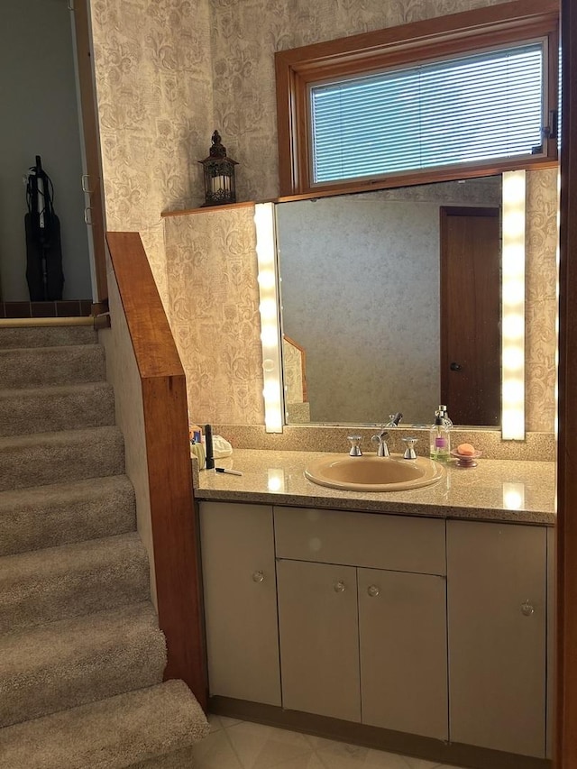bathroom featuring wallpapered walls, a healthy amount of sunlight, tile patterned flooring, and vanity
