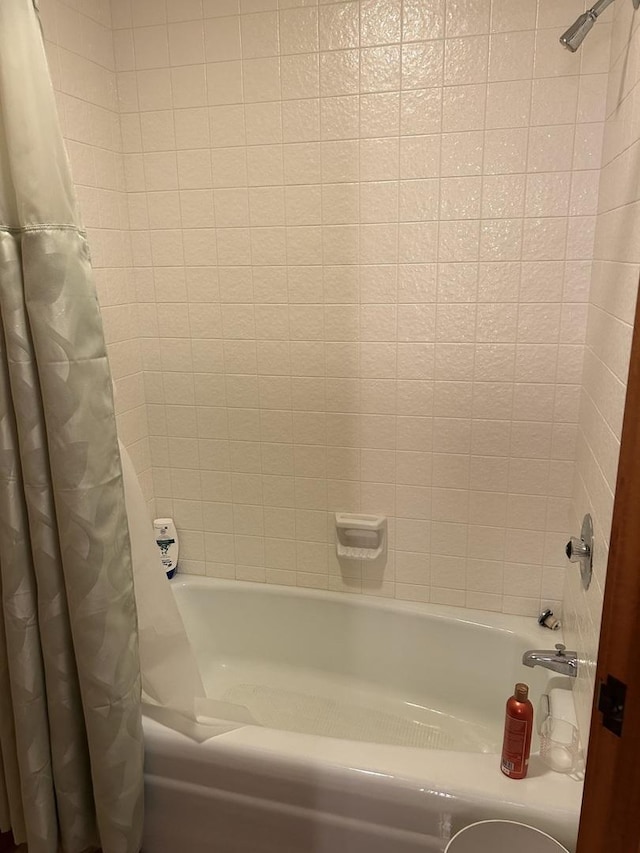 bathroom with shower / bath combination with curtain