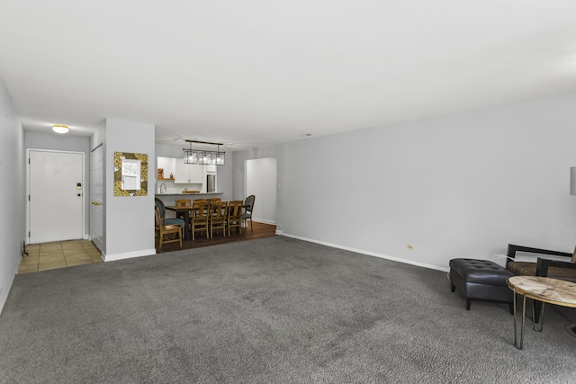 221 N Kenilworth Ave Unit 310, Oak Park, IL 60302 - living room featuring carpet flooring, baseboards, and a chandelier