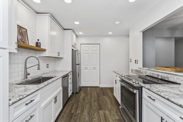 221 N Kenilworth Ave Unit 310, Oak Park, IL 60302 - kitchen with appliances with stainless steel finishes, a sink, dark wood-style flooring, white cabinetry, and recessed lighting