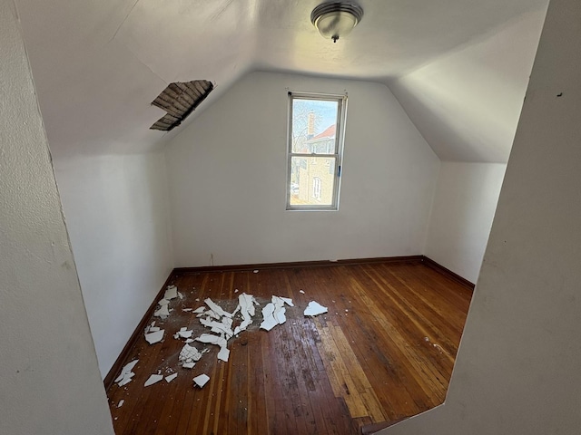 1649 N Latrobe Ave, Chicago, IL 60639 - additional living space with baseboards, hardwood / wood-style flooring, and lofted ceiling