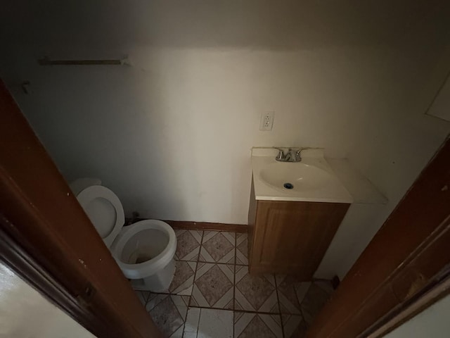 1649 N Latrobe Ave, Chicago, IL 60639 - bathroom with vanity, baseboards, tile patterned flooring, and toilet
