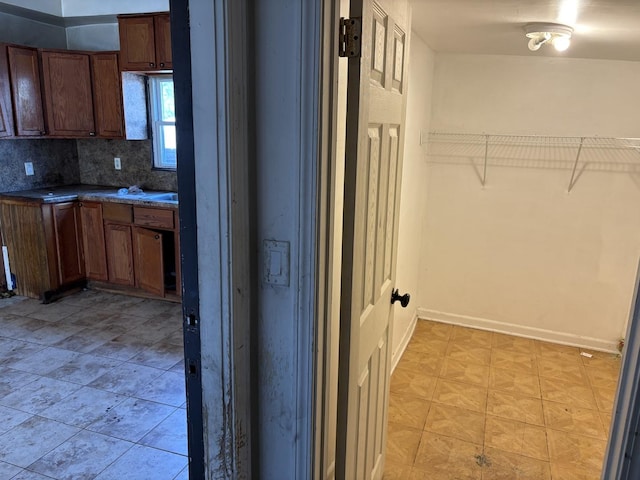 1649 N Latrobe Ave, Chicago, IL 60639 - kitchen featuring dark countertops, baseboards, and backsplash