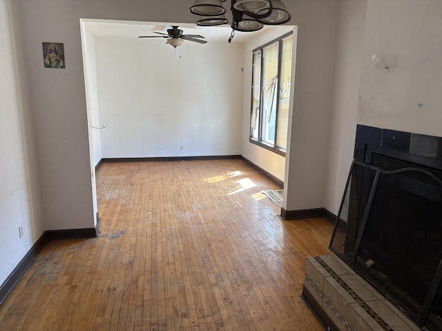1649 N Latrobe Ave, Chicago, IL 60639 - unfurnished living room with baseboards, ceiling fan with notable chandelier, and hardwood / wood-style floors