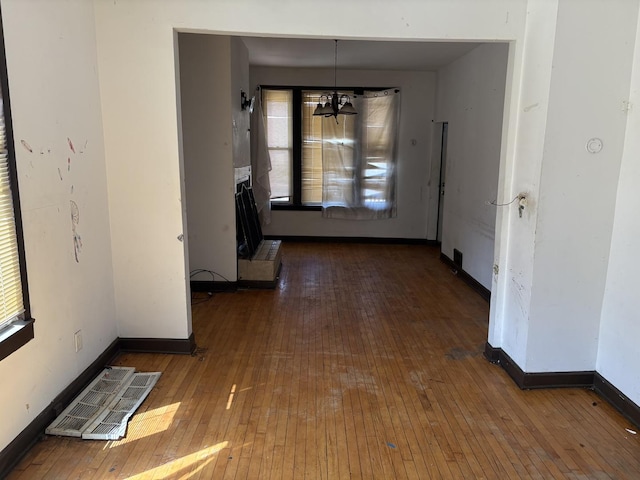 1649 N Latrobe Ave, Chicago, IL 60639 - corridor with wood-type flooring, baseboards, an inviting chandelier, and visible vents
