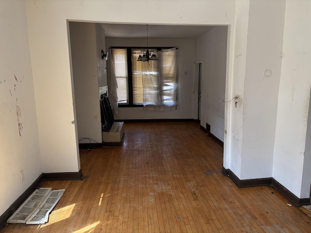 1649 N Latrobe Ave, Chicago, IL 60639 - unfurnished dining area with baseboards, an inviting chandelier, visible vents, and hardwood / wood-style floors