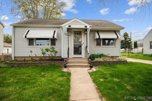 bungalow with fence and a front yard
