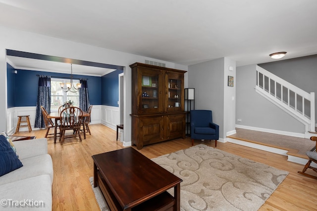 27W137 Chestnut Ln, Winfield, IL 60190 - living area with a chandelier, visible vents, light wood-style flooring, and a wainscoted wall